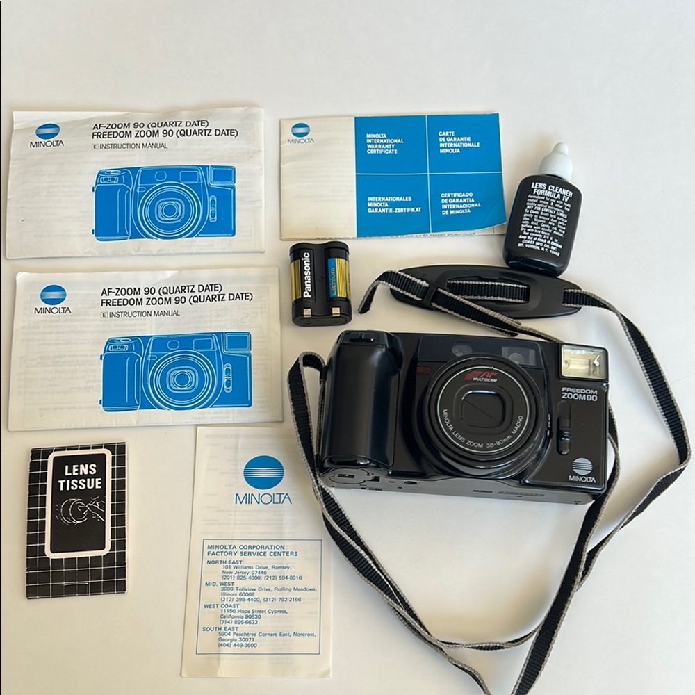 Vintage Minolta Camera with Classic Design and Accessories